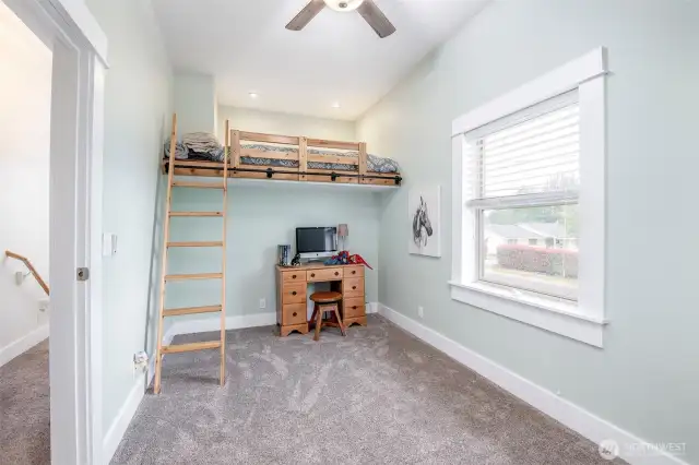 Across from the primary is another bedroom or play area.