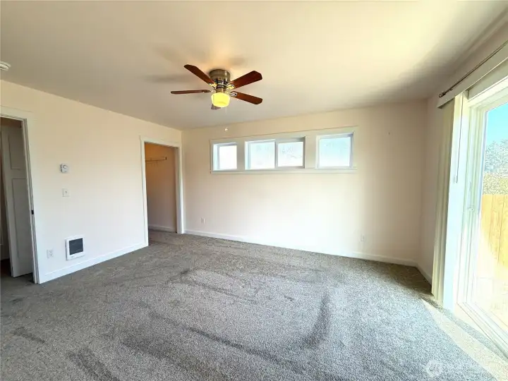 Master bedroom with loads of natural light and private patio