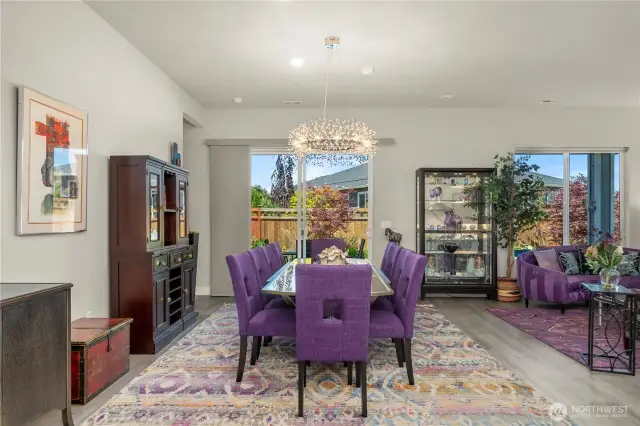 Generous dining area with the striking, high-end chandelier overlooks the beautiful backyard. This home is a fantastic one for entertaining friends and family!