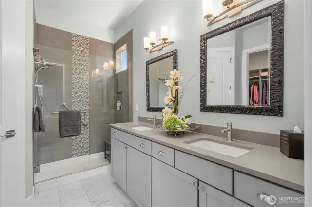 Primary bath offers Quarts counters, custom framed mirrors, tiled shower and flooring. Upgraded hardware as well.