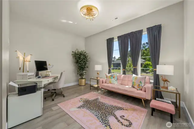 The guest en-suite offers a private sitting room, full bath, kitchenette and walk-in closet w/ built ins. The high-end chandelier is a great touch! A lovely spot for guests or family to retreat to. Their own private suite!