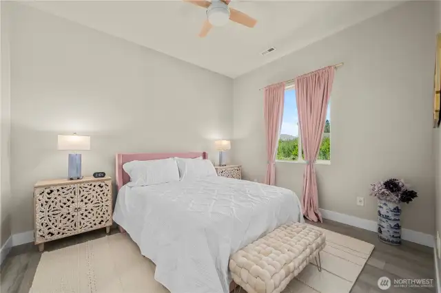 The second bedroom with adjacent sitting room offers your guests or family their own private space!  Engineered hardwoods and custom ceiling fan.