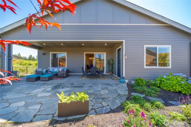 Huge flagstone patio overflows from the covered patio.  This home is begging to host friends and family!  Immense privacy and no home to the East!