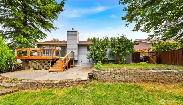 Landscaped back yard with deck and patio included!
