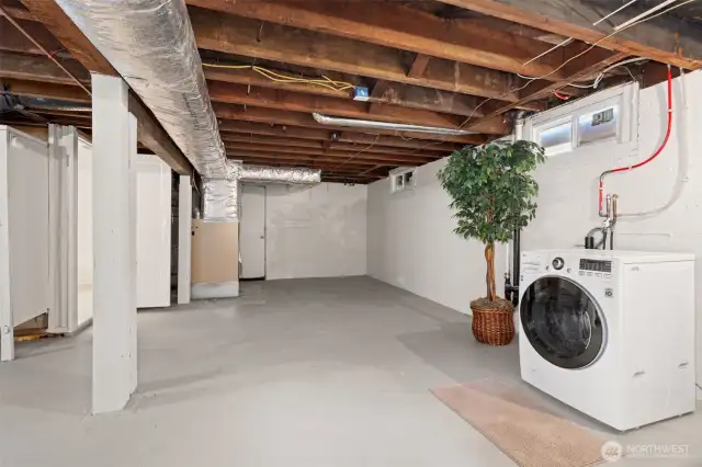 Another view of the sizable basement. The washer and dryer can be moved upstairs off the garage for true one-level living.