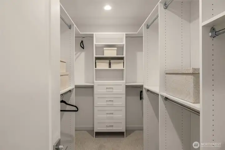 The primary suite features a walk-in closet with built in storage