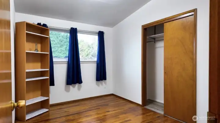 Guest room with beautiful hardwood floors.