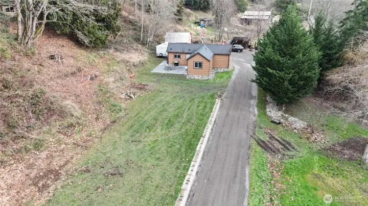 More of the level yard area & pull through driveway.