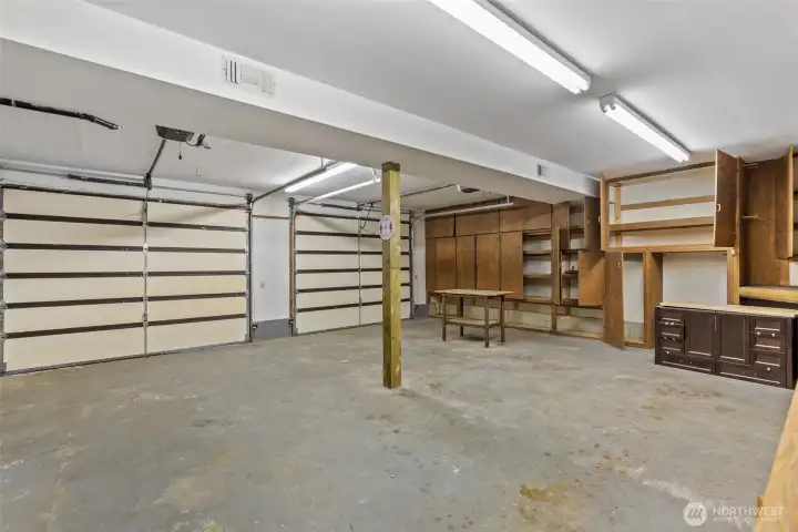 Oversized garage with storage and shop benches.
