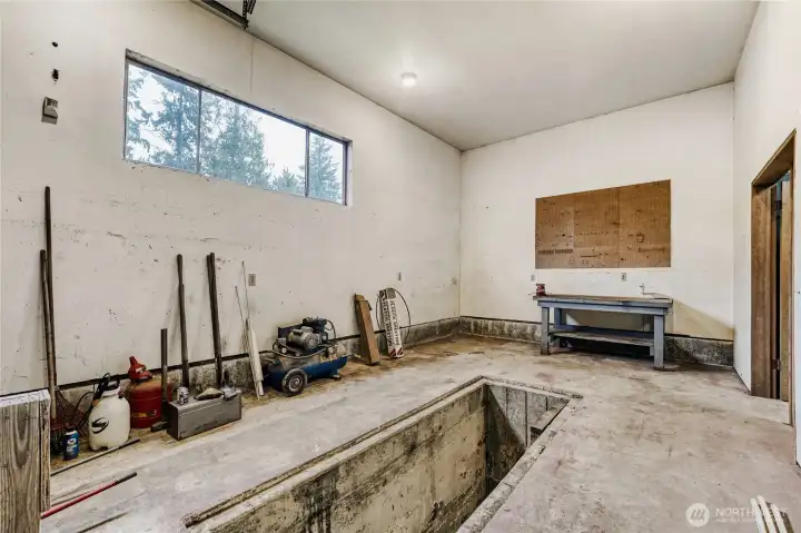 2nd bay in detached shop with maintenance pit.