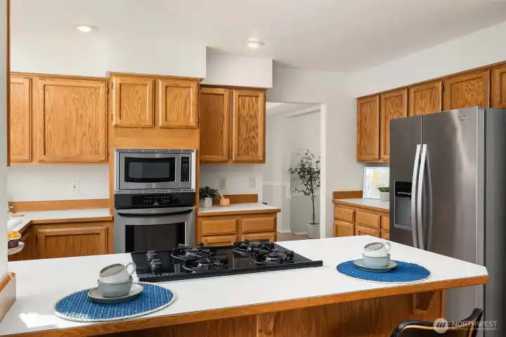 Chefs Kitchen Features a Breakfast Bar, Gas Cooktop, Wall Oven, and Stainless Steel Appliances - Ample Cabinets for Storage