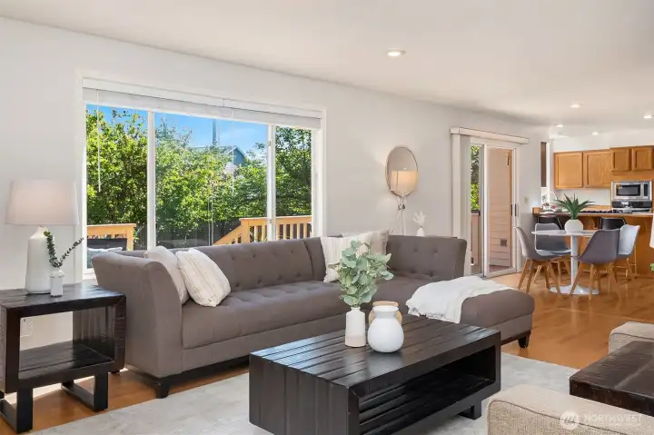 Family Room Featuring a Gas Fireplace, Hardwood Floors and Large Windows Streaming Natural Sunlight