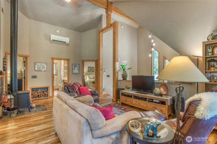 Timber frame accents at the top of the stairway and tall windows bring in natural light. This frame also shows both bedroom and bath doorways.