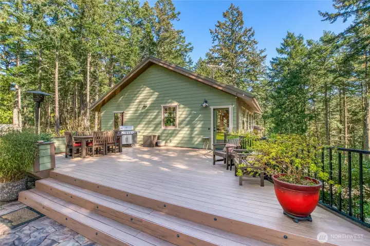 18.5'x25' Timber tech deck with built-in flower boxes, accessed from kitchen door, faces west.