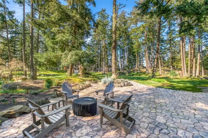 This property has been parked out and incorporates native landscapes and planned garden beds and naturalized areas. Looking towards the west, peak-a-boo view of Presidents Channel and outer islands through the trees along the ridge.