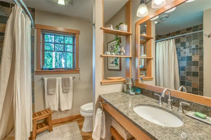 Full bath located between the two bedrooms. Ceramic tile tub/surround shower. Multi-function vent/light/night light/heater. Quartz counter top and ceramic wash basin. Custom medicine cabinet with built in power outlets.