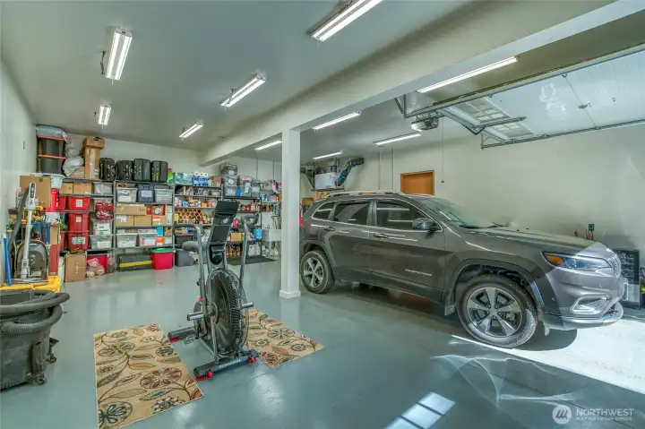 Large garage with overhead door and a man door (could be two car garage if you install another overhead garage door).