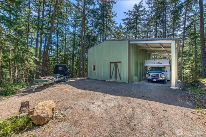 24x36 shop with RV parking. Utilities connect to building.