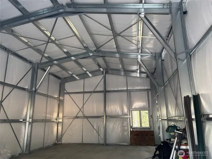 24x36 fully insulated shop with water, connected to 200-amp power panel. Electric hydronic heatng system in the shop. NOTE: sellers have filled this space with boxes and staging for their move.