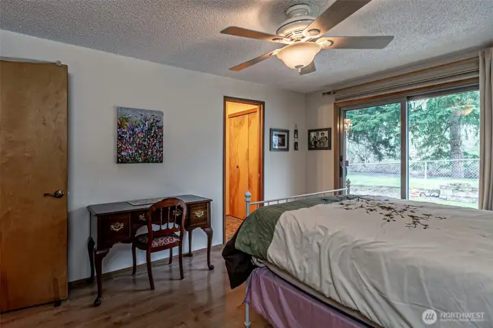 The primary bedroom has a patio door out to the river.