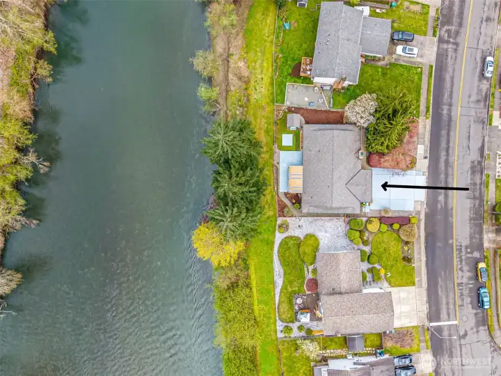 Overhead photo showing the home, the front and back yards, and the river.