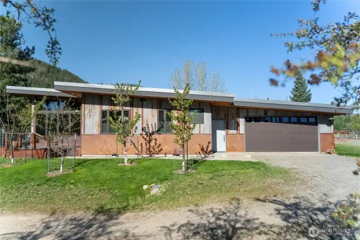 Fruit trees create the border along Burton St.