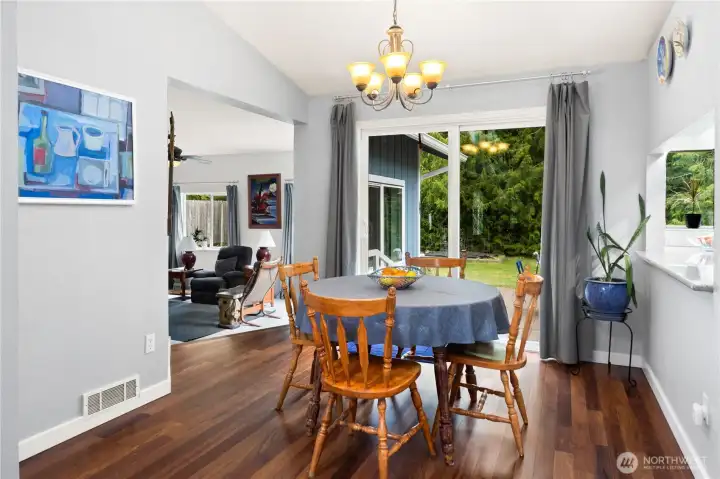 Dining room has a pass-through opening to the kitchen, a sliding glass door to the back yard. To the left you see the family room.