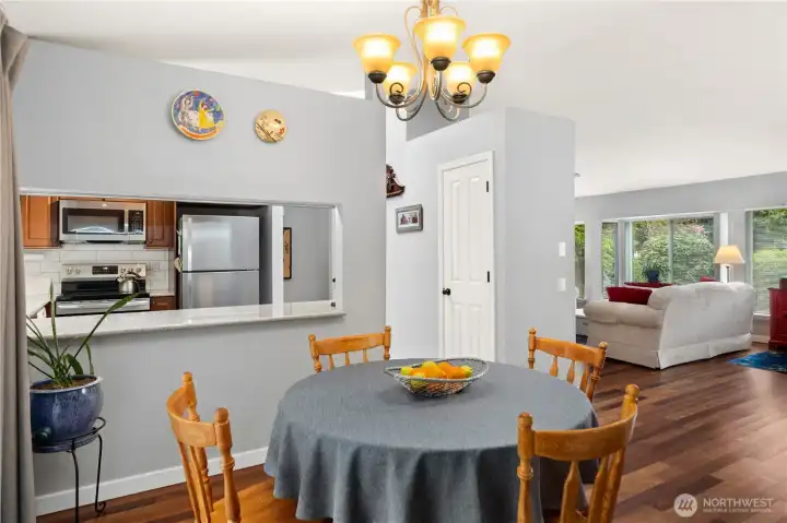 The flow in this house makes sense. View from the dining room looking towards the kitchen and the living room. One of the pantry closet doors is seen here.