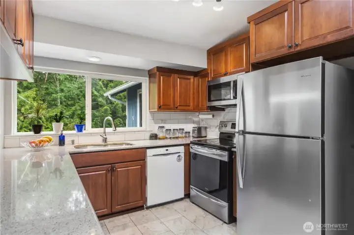 This kitchen has plenty of counterspace, deep sink and a new fridge. Easy U-shape makes everything convenient.