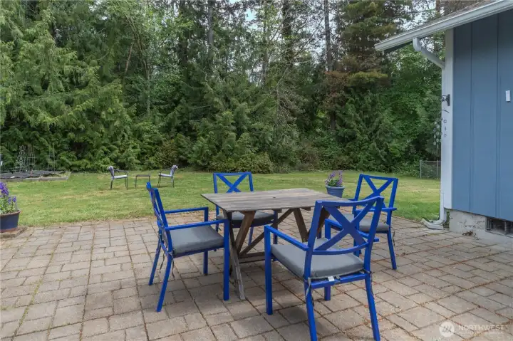 The patio offers another space to eat, entertain or relax. The trees in back are part of a green space.