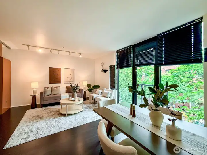 Floor-to-ceiling windows pull the neighborhood's tree canopy right into the living room.