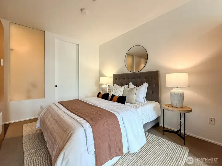 Layered bedding, natural light, and a room that feels put together without trying too hard.