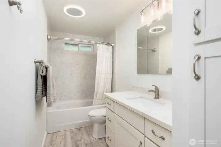 The remodeled main bathroom is just off the hallway. The remodeled main bathroom is just off the hallway.