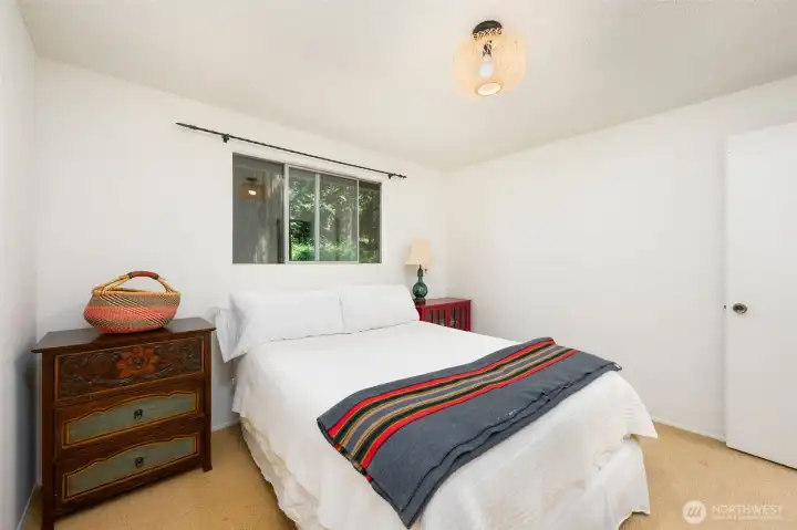 The primary bedroom backs up to the yard making it easy to listen to the babbling creek as you venture off to sleep in the evenings. The primary bedroom backs up to the yard making it easy to listen to the babbling creek as you venture off to sleep in the evenings.