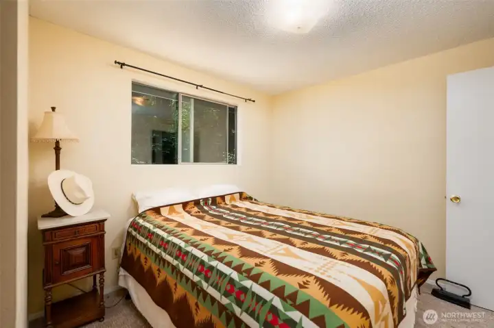 The second bedroom has able space for a queen sized bed and looks off into the front yard full of trees keeping it cool in the summer! The second bedroom has able space for a queen sized bed and looks off into the front yard full of trees keeping it cool in the summer!