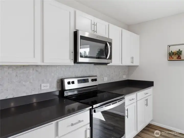 Marble tile herringbone backsplash above quartz countertops. Marble tile herringbone backsplash above quartz countertops.