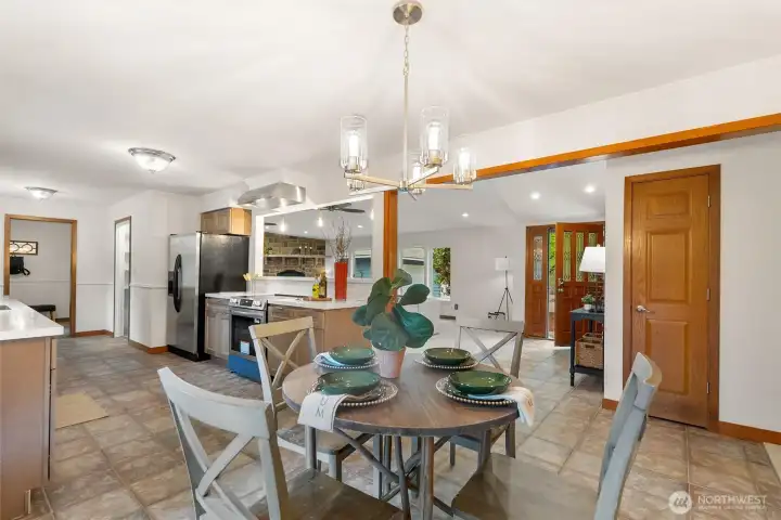 Updated kitchen with stainless steel appliances and eating space.