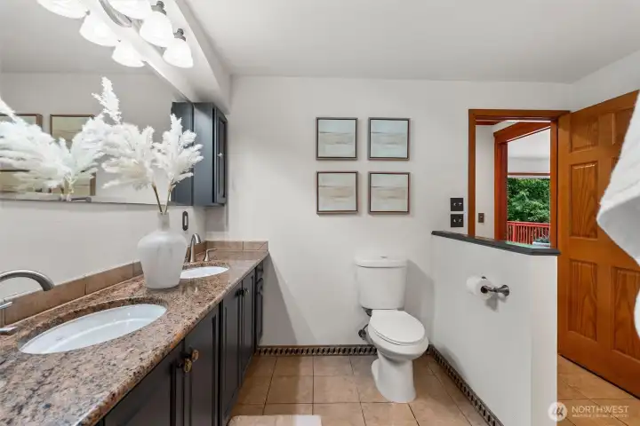 Beautiful primary bathroom, designed for relaxation.  Elegant finishes, including granite countertops, beautifully tiled shower and separate stand-along tub.