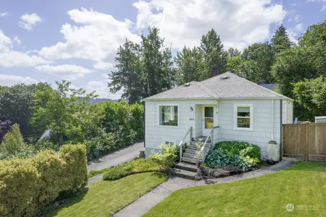 Sited on a sunny corner lot, the yard enjoys mature, low-maintenance plantings. Enjoy the bounty of fruit trees and well-established blueberry bushes!