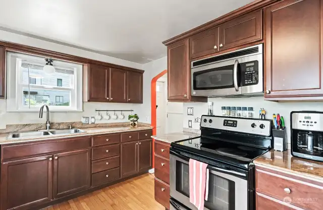 The kitchen features granite countertops, hardwood flooring and stainless steel appliances.
