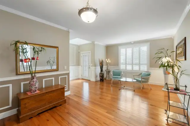 This spacious living room can be combined as a formal living and/or dining room. No expense spared with gorgeous plantation shutters on every window throughout this home!