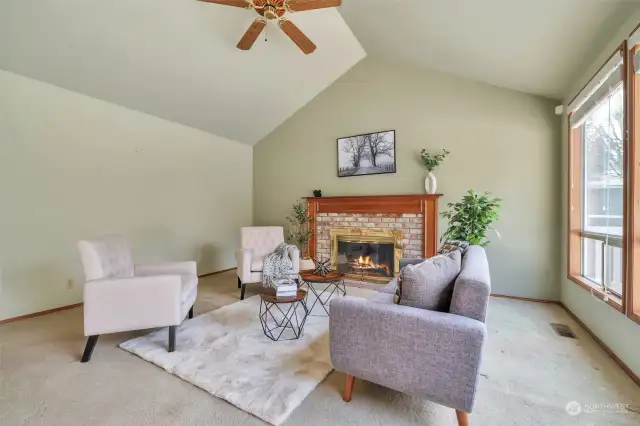 Step down into the formal living room with large windows bringing in natural light