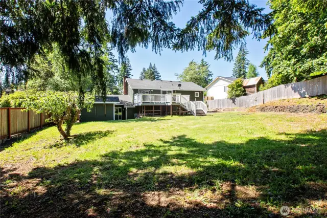 Sunny Backyard with Firepit & Large Shed.