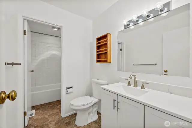 Full bathroom on the upper floor featuring a separate door for the shower area—designed for added privacy and convenience