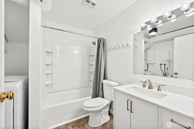 Spacious lower-level bathroom complete with laundry machines for added convenience