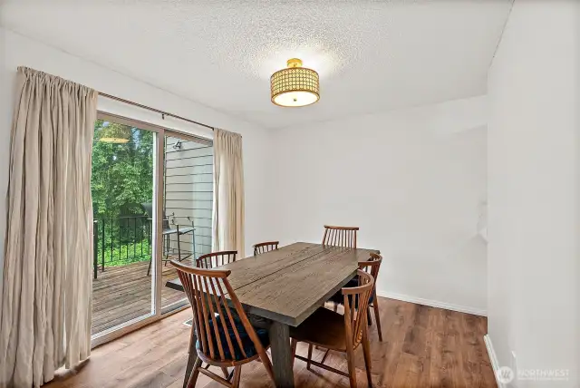 Bright dining area with abundant natural light and a sliding door that opens to the deck—perfect for indoor-outdoor living.