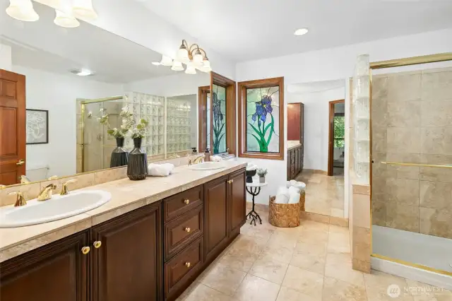 Large primary en suite with dual sinks and walk-in shower.