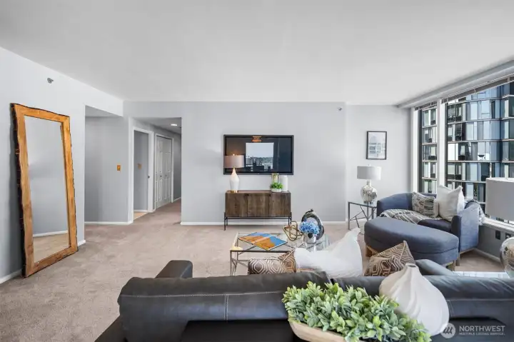 Flooded with natural light, this living room feels even more spacious and airy. The impressive windows showcase the home's most striking feature: the breathtaking views that change from day to night.