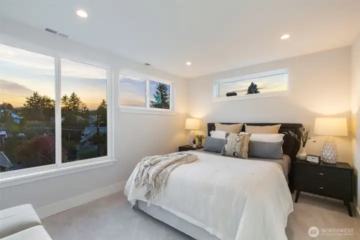 A primary suite with great windows and a lovely outlook.