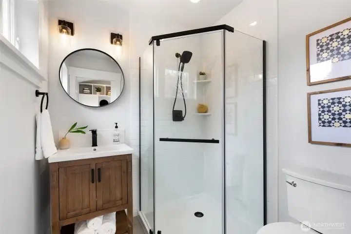 Tucked adjacent the mud room/drop zone, the main level bathroom. Easy cleaning for pets and people from life's outdoor fun.